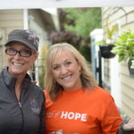 Women smile for camera while volunteering for Day of Hope.